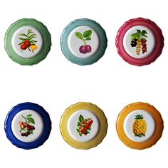 four plates with fruit painted on them