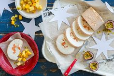 some food is laying out on the table with paper stars around it and plates full of food