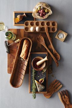 an overhead view of food and utensils on a cutting board, including bread