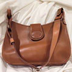 Beautiful, Well-Kept Vintage Dooney And Bourke Hobo Shoulder Bag. Camel Color Florentine Leather With Minor Marks. Great Condition. Made In The Usa. Matching Wallet In My Closet Height 8 1/2 Inches Tall Width 12 Inches Depth 3 Inches The Strap Is Adjustable Hobo Purses Dooney & Bourke, Vintage Dooney And Bourke, Dooney And Bourke, Dooney & Bourke Bags, Camel Color, Dooney & Bourke, Dooney Bourke, Leather Purses, Camel