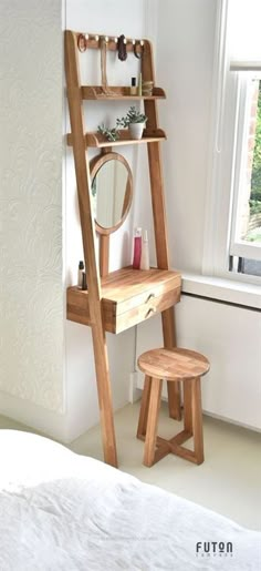 a wooden ladder is next to a mirror and stool in a room with white walls