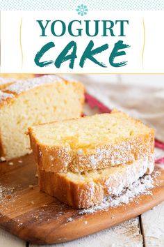 a loaf of yogurt cake sitting on top of a wooden cutting board with powdered sugar