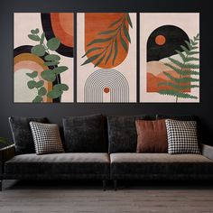 three paintings hang on the wall above a couch