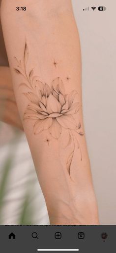 a woman's arm with a flower tattoo on the left side of her body