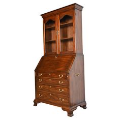 an old fashioned wooden desk with drawers on it's top and bottom shelf, against a white background