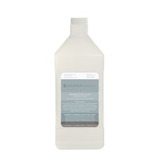 a gallon of white liquid on a white background with the label in grey and black