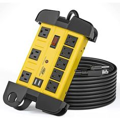 a yellow and black power strip sitting on top of an extension cord