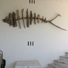 driftwood pieces are arranged on the wall next to stairs