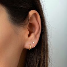 "Dainty open hoop huggie earrings featuring a tiny polished disc. Simple, tiny and versatile, they're perfect for wearing in a first or second earhole, on a cartilage piercing or all by themselves for the tiniest addition to your everyday look. * D E T A I L S * ∙ Sold individually (1 earring) or as a pair (2 earrings) ∙ Material: .925 Sterling Silver or 18K Gold Plated over .925 Sterling Silver ∙ Dimensions: Hoop diameter: 9mm // Tiny disc diameter: 3mm ∙ Hypoallergenic & nickel-free * P A C K Second Stud Earrings, Tiny Gold Studs, Dainty Gold Earrings, Everyday Earrings Studs, Gold Dot, Tiny Hoop Earrings, Open Hoop Earrings