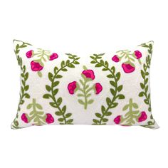 a white pillow with pink flowers and green leaves