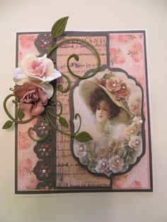 a close up of a card with flowers and a woman's face on it