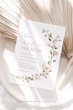 a wedding shower is shown with flowers on the front and back of it, next to an open book