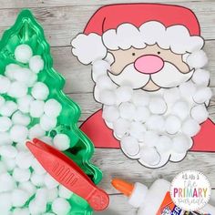 a santa clause cut out next to some gummy balls