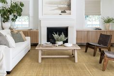 a living room filled with furniture and a fire place under a painting on the wall