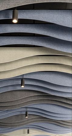 an array of different shades of paper hanging from the ceiling in a store or office