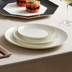 a table topped with plates and glasses of wine