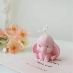 an elephant keychain sitting on top of a card