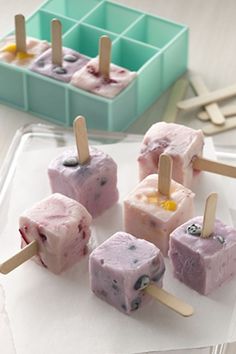 several popsicles are on a tray with toothpicks