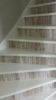 the stairs are painted white and have wooden planks