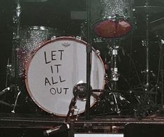 a drum set with the words let it all out written on it