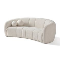 a white couch with two balls on it's back and the seat upholstered