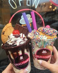 two ice cream sundaes with chocolate and sprinkles