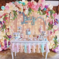 a table with balloons and decorations on it