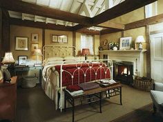 a bedroom with a bed and fireplace in it