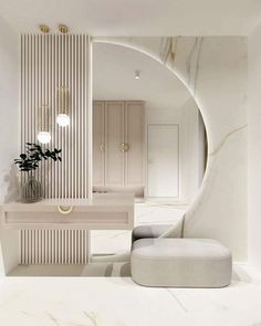 a white bathroom with marble counter tops and an oval mirror over the sink, along with a stool