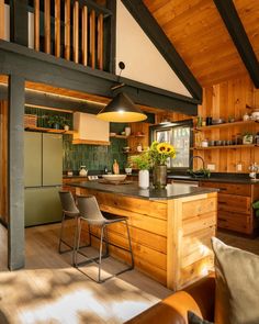 an open kitchen with wooden walls and flooring