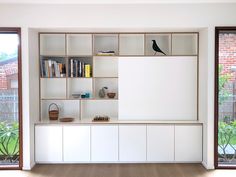 an empty room with bookshelves and sliding glass doors