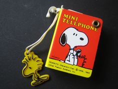 a yellow and red cell phone with a cartoon snoopy dog on it's back