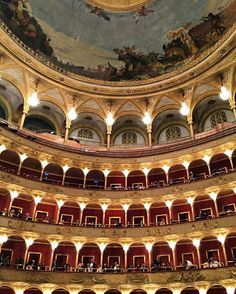 the interior of an old theater with painted ceiling