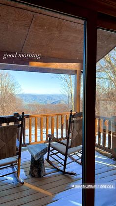 two rocking chairs sitting on top of a wooden deck next to a snow covered forest