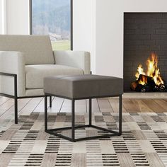 a chair and footstool in front of a fire place with an open fireplace