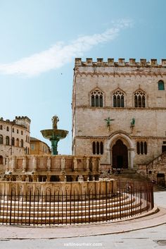 an old building with a fountain in front of it