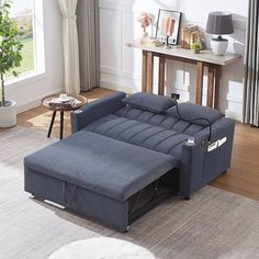 a living room filled with furniture and a rug on top of a hard wood floor