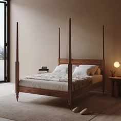 there is a bed with four posts in the room