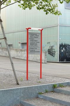 there is a sign in front of a building with graffiti on the walls and stairs