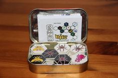 an open tin box filled with magnets on top of a wooden table