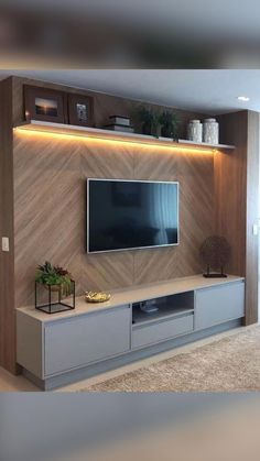 an entertainment center with a flat screen tv mounted on the wall