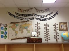 there is a world map on the wall and many other things are hanging from the ceiling