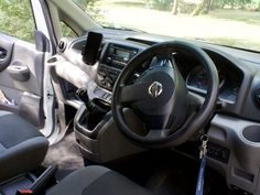 the interior of a vehicle with steering wheel and dashboard