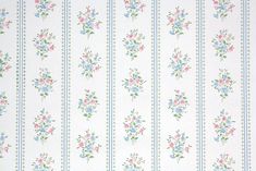 a white wallpaper with blue and pink flowers on it