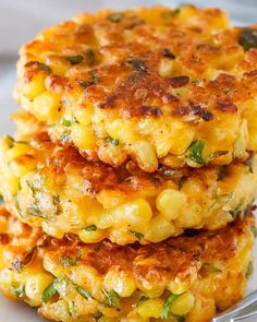 three corn cakes stacked on top of each other, with parsley in the background