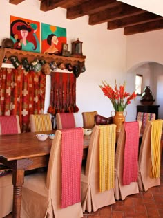 the dining room table is covered with colorful linens