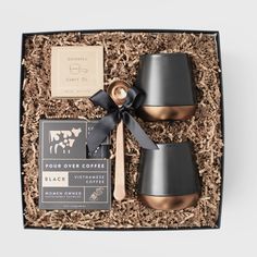 the gift box contains two cups, spoons and chocolate