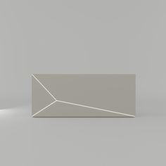 a white rectangular object sitting on top of a gray floor next to a light bulb