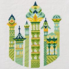 a cross stitch pattern with buildings on it