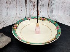 a decorative bowl with an umbrella sticking out of it